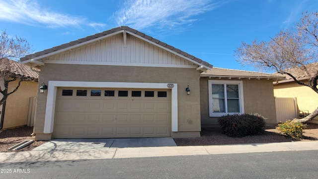 ranch-style house featuring a garage, a tile roof, concrete driveway, and stucco siding