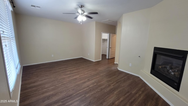 unfurnished living room with ceiling fan and dark hardwood / wood-style floors