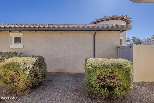1170 S Agnes Ln, Gilbert, AZ 85296 - view of home's exterior featuring stucco siding, a gate, fence, and a tiled roof
