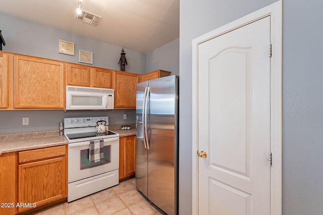 kitchen featuring white appliances and light tile patterned floors