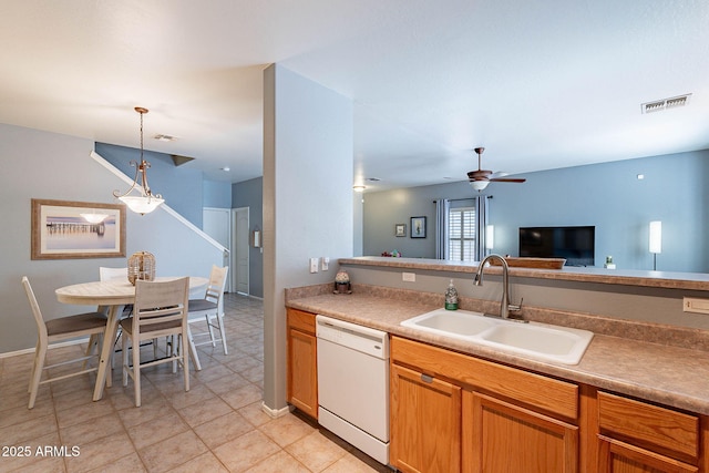 kitchen featuring light tile patterned floors, ceiling fan, white dishwasher, hanging light fixtures, and sink