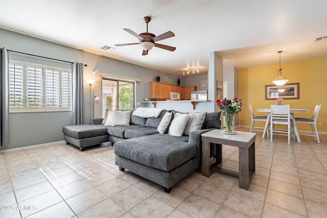 tiled living room featuring ceiling fan