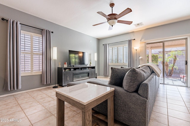 tiled living room with ceiling fan