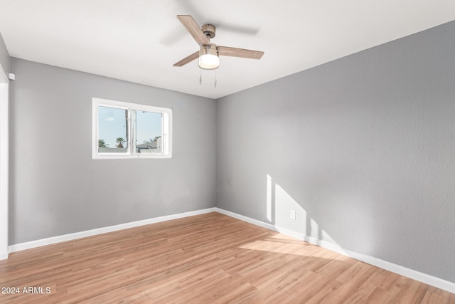 spare room featuring ceiling fan and light wood-type flooring