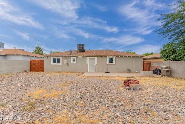 rear view of property with a patio and cooling unit