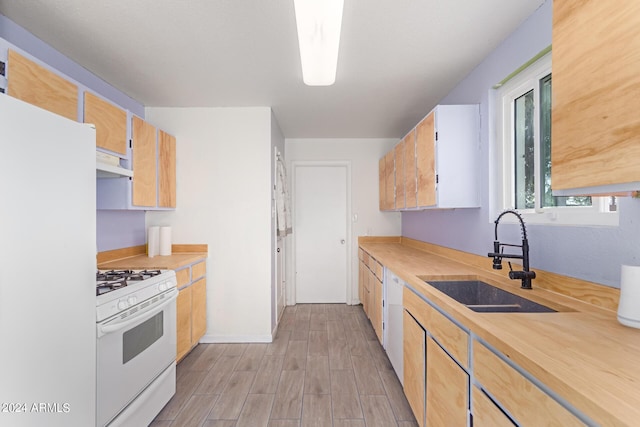 kitchen with sink, light hardwood / wood-style flooring, white appliances, and ventilation hood