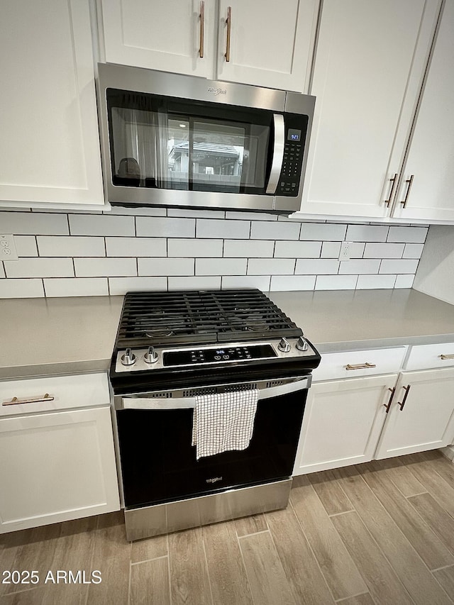 kitchen with appliances with stainless steel finishes and white cabinets