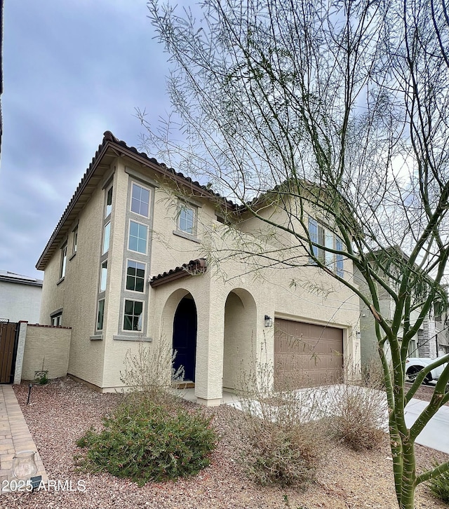 mediterranean / spanish-style home featuring a garage