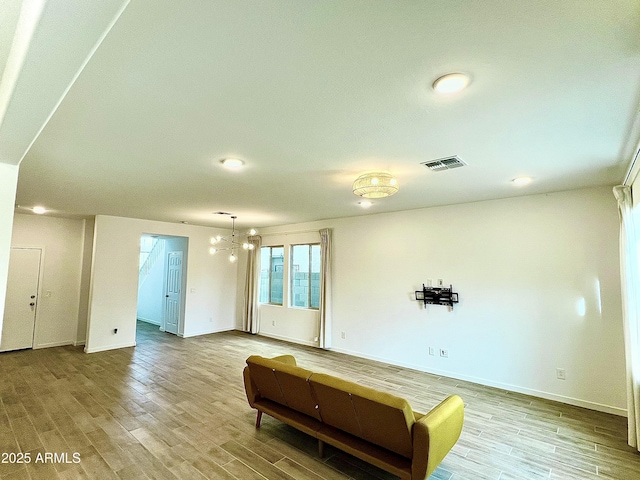 interior space featuring an inviting chandelier and light hardwood / wood-style floors