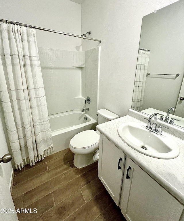 full bathroom with shower / bathtub combination with curtain, vanity, and toilet