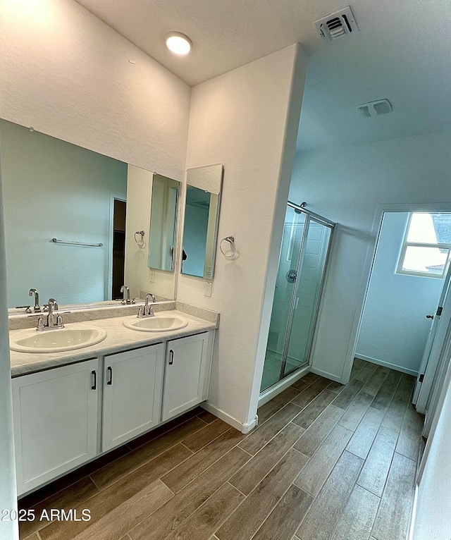 bathroom with vanity and an enclosed shower