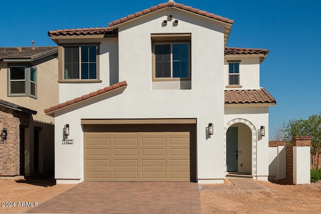 mediterranean / spanish house with a garage