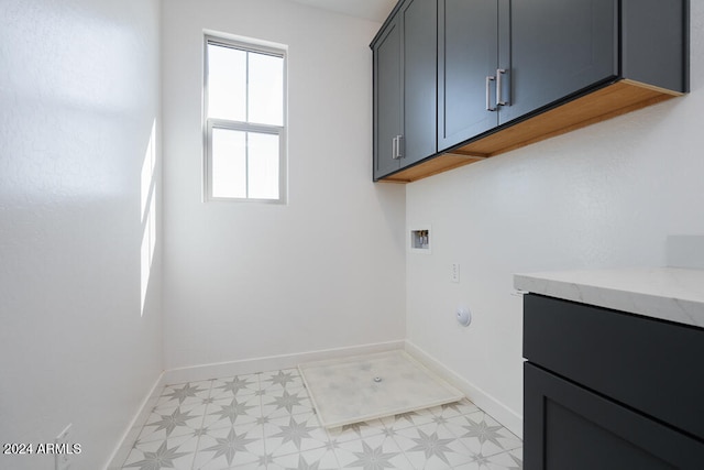 washroom featuring washer hookup and cabinets