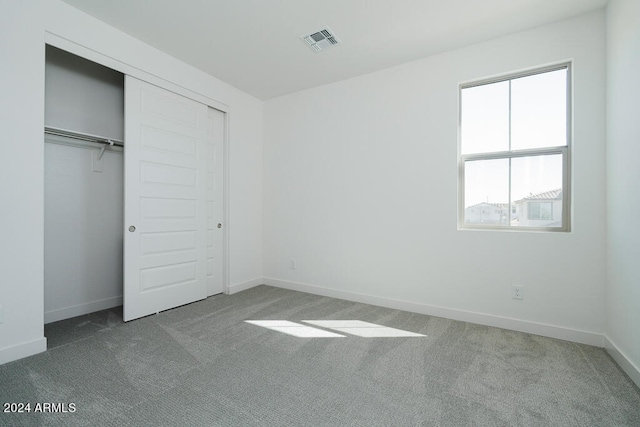 unfurnished bedroom featuring a closet and carpet