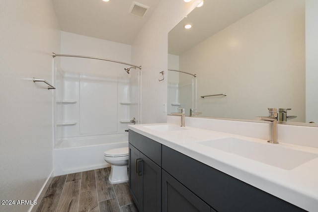 full bathroom featuring vanity, toilet, wood-type flooring, and shower / bathtub combination