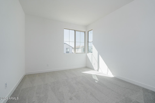 spare room with light colored carpet