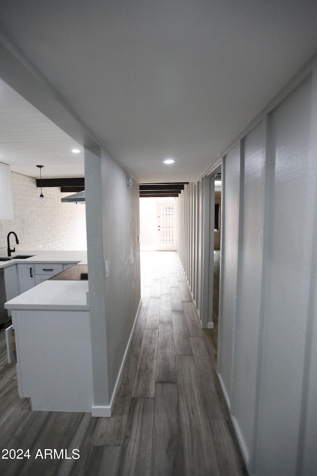 corridor with sink and dark wood-type flooring