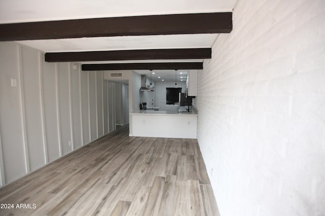 interior space with beam ceiling and light wood-type flooring