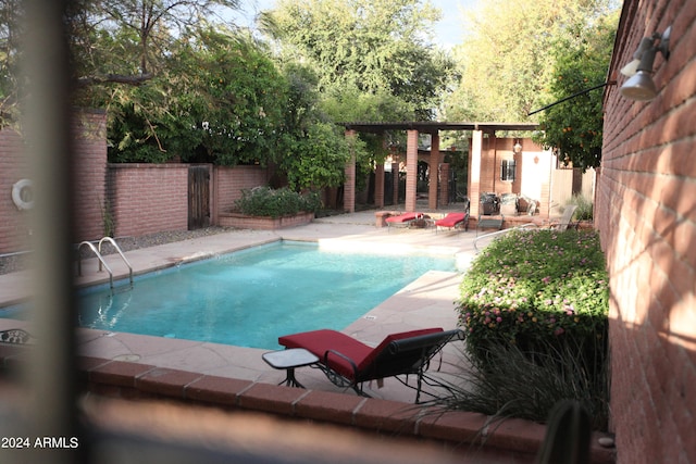 view of pool with gas water heater and a patio area