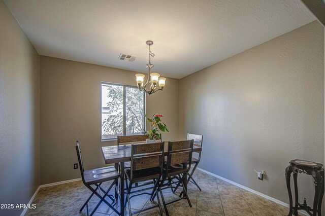 6811 W Darrel Rd, Laveen, AZ 85339 - dining area with a notable chandelier, baseboards, and visible vents