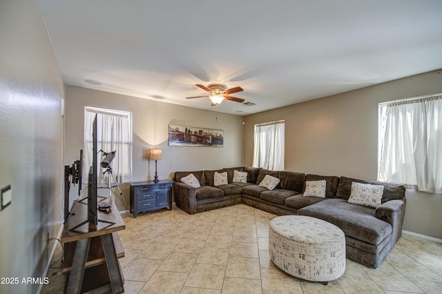 6811 W Darrel Rd, Laveen, AZ 85339 - living room with ceiling fan, baseboards, light tile patterned floors, and plenty of natural light