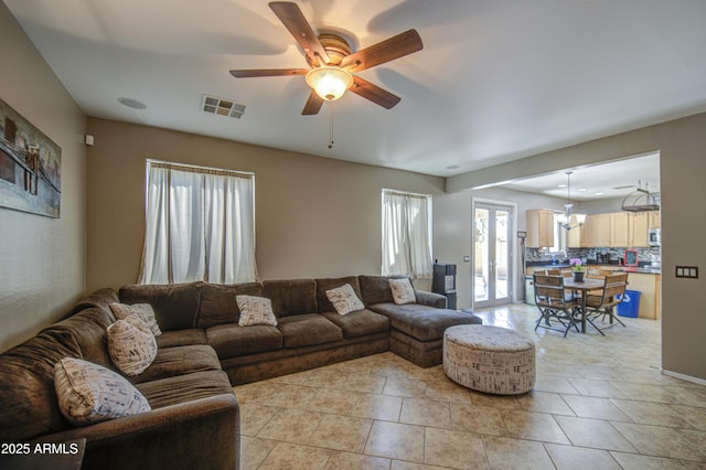 6811 W Darrel Rd, Laveen, AZ 85339 - living area featuring ceiling fan with notable chandelier, light tile patterned floors, and visible vents