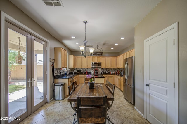 6811 W Darrel Rd, Laveen, AZ 85339 - kitchen featuring stainless steel appliances, visible vents, backsplash, light brown cabinetry, and dark countertops