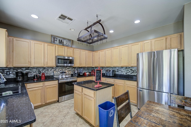 6811 W Darrel Rd, Laveen, AZ 85339 - kitchen featuring stainless steel appliances, light brown cabinets, a sink, and visible vents