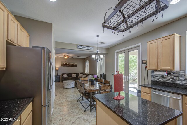 6811 W Darrel Rd, Laveen, AZ 85339 - kitchen with light brown cabinets, a center island, open floor plan, decorative backsplash, and stainless steel appliances