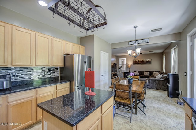 6811 W Darrel Rd, Laveen, AZ 85339 - kitchen with freestanding refrigerator, light brown cabinets, an inviting chandelier, visible vents, and open floor plan