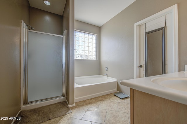 6811 W Darrel Rd, Laveen, AZ 85339 - full bathroom featuring tile patterned flooring, a garden tub, a shower stall, and baseboards
