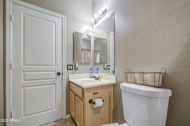 6811 W Darrel Rd, Laveen, AZ 85339 - half bath with vanity, toilet, a textured wall, and tile patterned floors