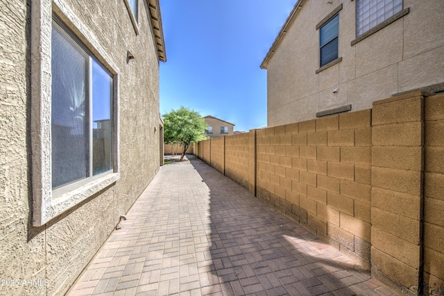 6811 W Darrel Rd, Laveen, AZ 85339 - view of side of property with a patio area, stucco siding, and a fenced backyard