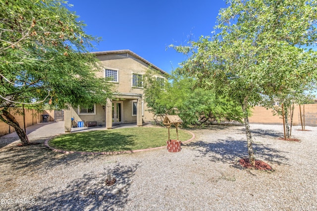 6811 W Darrel Rd, Laveen, AZ 85339 - rear view of house with a fenced backyard, a patio area, stucco siding, and a lawn