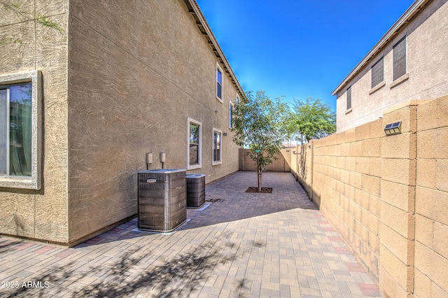 6811 W Darrel Rd, Laveen, AZ 85339 - exterior space featuring central AC unit, stucco siding, a fenced backyard, and a patio