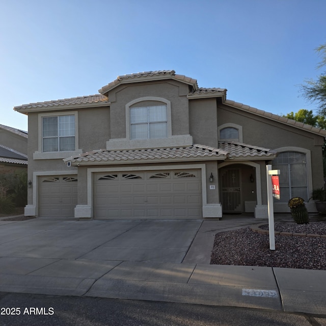 1032 E Sheffield Ave, Chandler, AZ 85225 - view of front of house featuring a garage, a tiled roof, driveway, and stucco siding