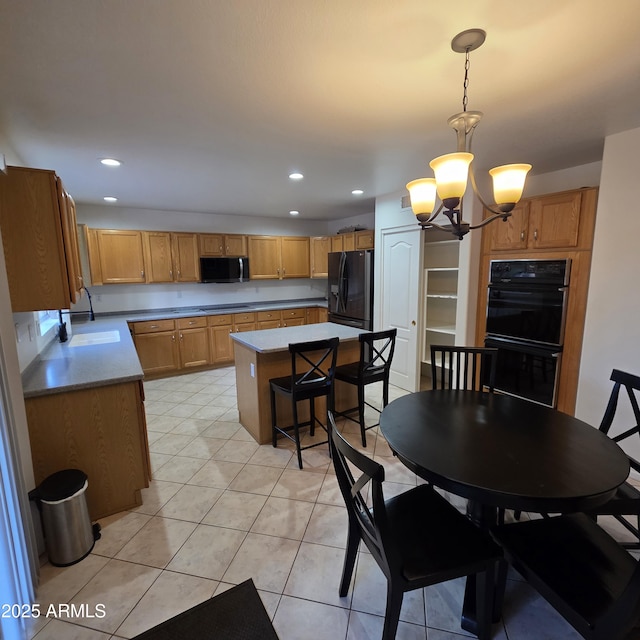 1032 E Sheffield Ave, Chandler, AZ 85225 - kitchen featuring black appliances, a chandelier, decorative light fixtures, a kitchen island, and light tile patterned floors
