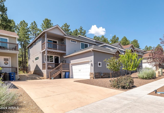 view of front of home with a balcony and a garage