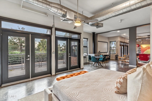 bedroom featuring french doors, access to exterior, and concrete flooring