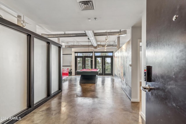 interior space with french doors and concrete floors