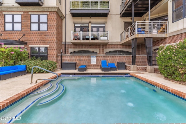 view of swimming pool with a patio