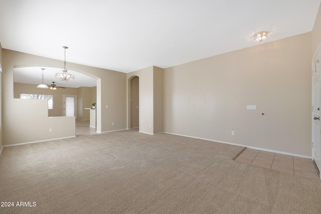 spare room with ceiling fan, light colored carpet, and lofted ceiling