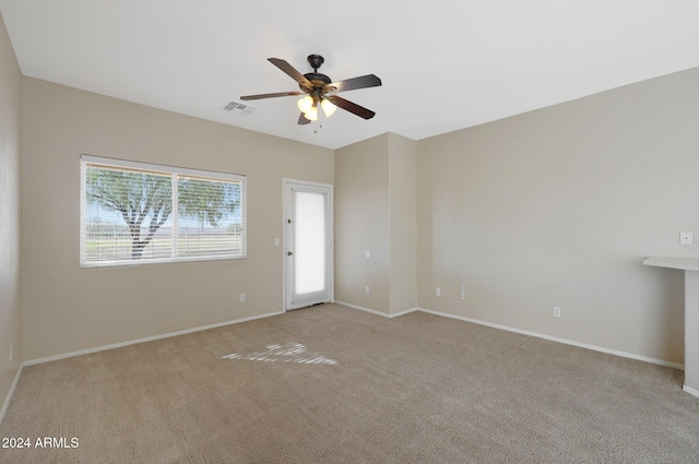 unfurnished room with ceiling fan and light carpet