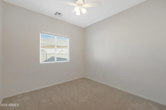 unfurnished room with light colored carpet and ceiling fan