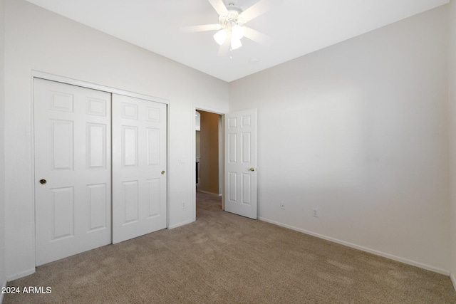 unfurnished bedroom featuring carpet, ceiling fan, and a closet