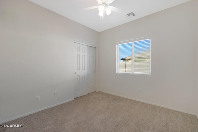 carpeted empty room with ceiling fan