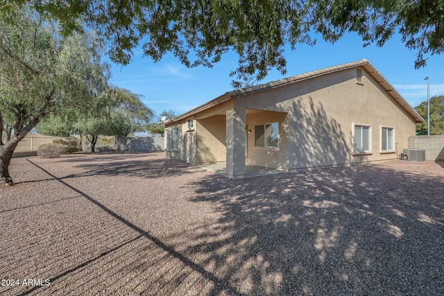 rear view of house featuring a patio and central AC