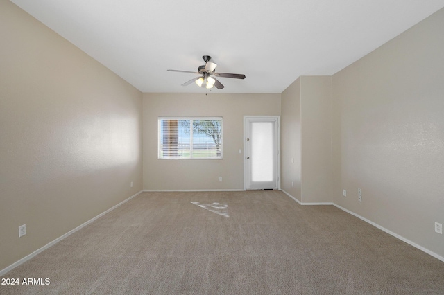 spare room with light colored carpet and ceiling fan