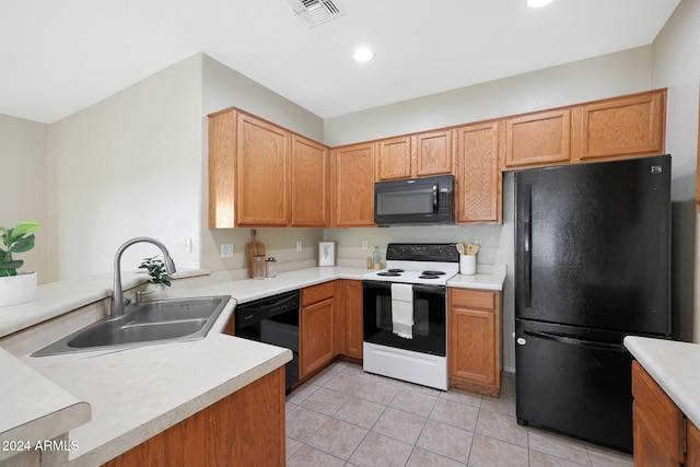 kitchen with light tile patterned floors, sink, and black appliances