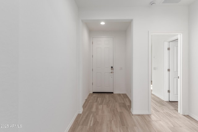 corridor with light wood-type flooring